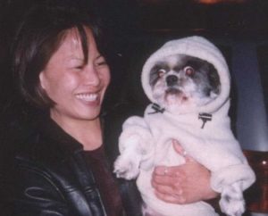 Karen Tsang and puppy in a hoodie